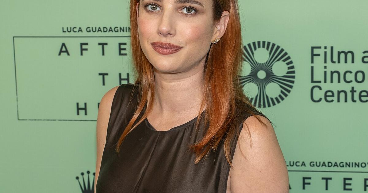 Emma Roberts smiling in chic press setting