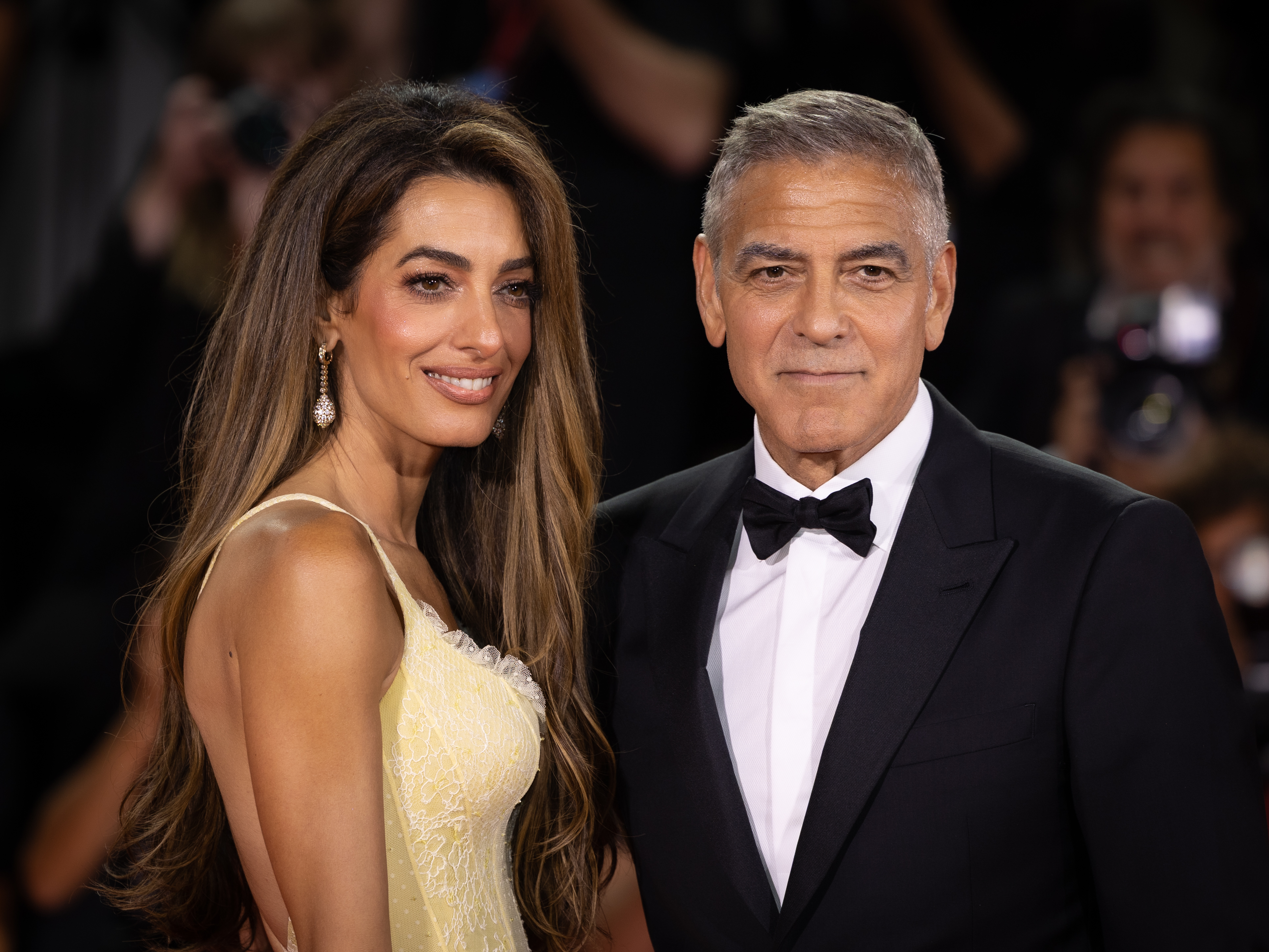 Amal and George Clooney attending red carpet gala