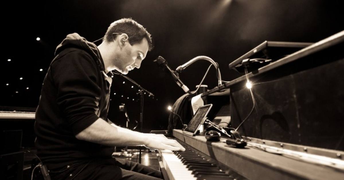 Johnny McDaid performing on stage with Snow Patrol