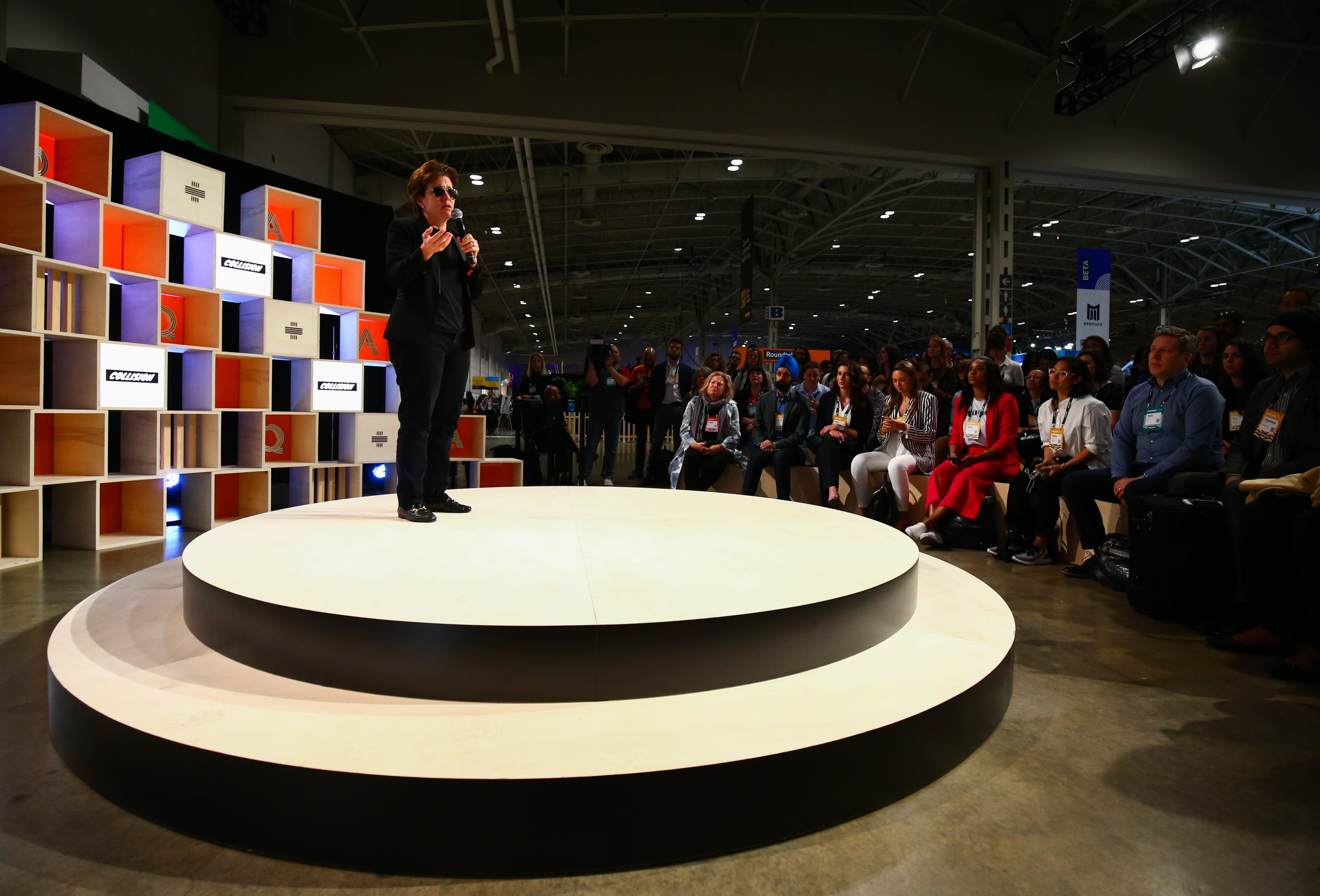 Kara Swisher speaking on stage at a tech conference