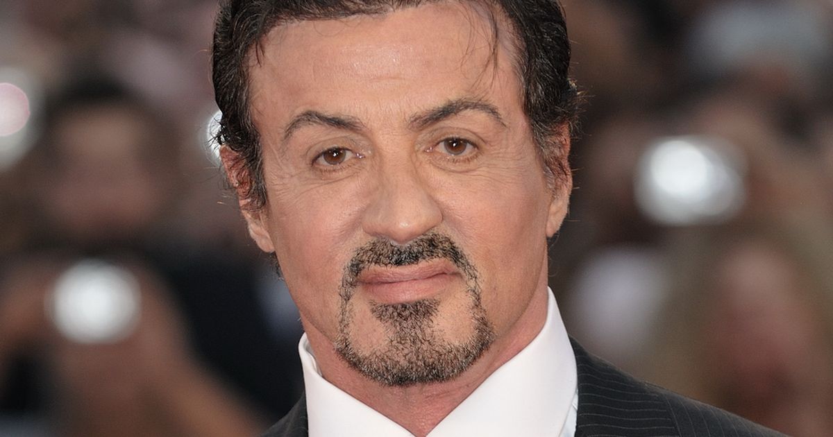 Sophia Stallone and Sylvester Stallone smiling together at an evening event